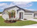 Beautiful single-Gathering home featuring a manicured lawn, and a welcoming front entry at 1645 Nantucket Way, Winter Haven, FL 33884