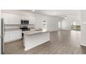 Bright, open-concept kitchen with stainless steel appliances and a center island overlooking the living area at 1645 Nantucket Way, Winter Haven, FL 33884