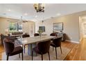 Bright dining room with a modern table, stylish chairs, and an adjacent cozy living area, perfect for entertaining and relaxing at 1892 Sanderling Dr, Clermont, FL 34711