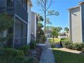 View of walkway of a condo complex with stairs and plants at 3700 Idlebrook Cir # 206, Casselberry, FL 32707