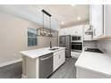 Modern kitchen featuring white cabinets, stainless steel appliances, and a large island with a sink at 7701 Somersworth Dr, Kissimmee, FL 34747