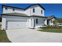 Charming two-story home featuring a two-car garage, manicured lawn, and beautifully painted exterior at 1653 Nantucket Way, Winter Haven, FL 33884