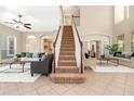 Bright living room with a staircase, neutral decor, and an open layout perfect for entertaining at 3930 Cassia Dr, Orlando, FL 32828