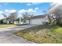 Well-maintained single-Gathering home featuring a two-car garage and a spacious driveway at 326 Sand Pine Trl, Winter Haven, FL 33880