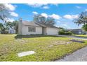 Well-maintained single-Gathering home featuring a two-car garage and a spacious front yard at 326 Sand Pine Trl, Winter Haven, FL 33880