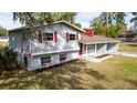 Charming two-story home with red shutters, gray siding, and well-manicured lawn at 1326 Se 34Th Ter, Ocala, FL 34471