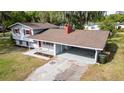 Charming two-story home with a carport, gray siding, and a red chimney at 1326 Se 34Th Ter, Ocala, FL 34471