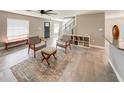 Bright living room features modern tile flooring and contemporary furnishings with a view of the staircase at 5235 Nichols E Dr, Lakeland, FL 33812