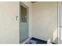 Close-up of the front door with decorative glass panel and a welcome mat inside a small alcove at 642 Lake Dexter Cir, Winter Haven, FL 33884