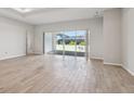 Open floor plan featuring sliding glass doors that let in abundant light, as well as a wood look flooring at 3158 Sailing Pier Ave, Winter Garden, FL 34787