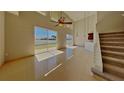 Open-concept living room featuring soaring ceilings, tile flooring, and sliding glass doors to the backyard at 539 Lakeview Dr, Poinciana, FL 34759