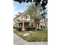 Street view of inviting townhomes with lush landscaping and charming architectural details at 3301 Soho St # 102, Orlando, FL 32835