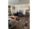 Cozy living room features wood floors, a modern entertainment center, and ample natural light at 3324 Parkchester Square Blvd # 102, Orlando, FL 32835