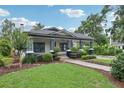Well-maintained home featuring a wide front lawn and inviting covered porch at 515 Frank Lloyd Wright Way, Lakeland, FL 33803