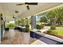 Spacious front porch with decorative tile flooring and stylish ceiling fans for outdoor comfort at 515 Frank Lloyd Wright Way, Lakeland, FL 33803