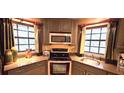 Close up shot of kitchen with stainless steel appliances and stone countertops at 472 Blue Heron Cir, River Ranch, FL 33867