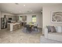 Open kitchen and dining area featuring stainless steel appliances and a center island with bar stool seating at 8249 Sw 52Nd Lane Rd, Ocala, FL 34481