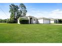 Charming single-story home with lush green lawn and attached two car garage at 143 Inconnu Ct, Kissimmee, FL 34759