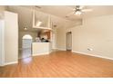 The living room features vaulted ceilings and stylish laminate flooring at 143 Inconnu Ct, Kissimmee, FL 34759