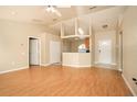 The living room features vaulted ceilings and stylish laminate flooring at 143 Inconnu Ct, Kissimmee, FL 34759