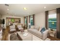 Bright living room seamlessly connects to an open-concept kitchen and dining area at 5433 Sw 82Nd Ter, Ocala, FL 34481