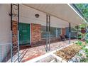 Covered front porch with brick flooring and a front door with address at 7013 Beverly Rd, Lakeland, FL 33813