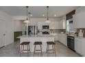 Bright kitchen with stainless steel appliances, eat-in island, white cabinetry, and stylish pendant lighting at 8207 Sw 52Nd Lane Rd, Ocala, FL 34481