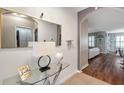 Bright foyer with neutral walls, tile flooring, archway to living area and a glass console table with mirror at 1780 Jackson Oaks Dr, Bartow, FL 33830