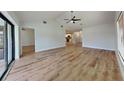 Open-concept floorplan with vaulted ceilings seamlessly connects the living room to the kitchen at 23 Buck Cir, Haines City, FL 33844