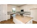 Bright kitchen featuring white cabinets, modern appliances, and a center island at 5831 Sw 87Th Ave, Ocala, FL 34481