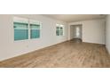 Open-concept living room with wood-look tile flooring and plenty of natural light at 5831 Sw 87Th Ave, Ocala, FL 34481