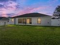 Lush backyard with well-maintained grass, a screened-in patio and a privacy fence at 6272 Cornerstone Dr, Lakeland, FL 33813