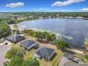 Breathtaking aerial view showcasing a lakefront property with lush greenery, neighboring houses and serene lakeside scenery at 917 Shawna Shrs, Haines City, FL 33844