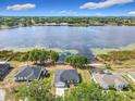 Stunning aerial perspective featuring a waterfront house, revealing its private backyard and the picturesque lake at 917 Shawna Shrs, Haines City, FL 33844