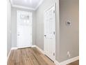 Bright and welcoming foyer with wood-look floors, white trim, and neutral paint, creating a clean and modern entrance at 917 Shawna Shrs, Haines City, FL 33844