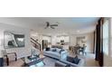Bright and airy living room with an open floor plan, flowing into dining area and modern kitchen at 1919 Blissful Dr, Kissimmee, FL 34744