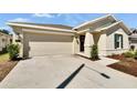Well-maintained home exterior with a two-car garage, neat landscaping, and a welcoming entrance, enhancing curb appeal at 272 Pershing St, Bartow, FL 33830