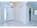 Entryway with tile flooring, closet, overhead lighting, and a sidelight window by the front door at 3518 Remington Oaks Way, Lakeland, FL 33810