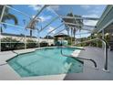 Inviting screened-in pool with clear blue water, poolside seating, and a well-maintained patio area at 7402 Gunstock Dr, Lakeland, FL 33809