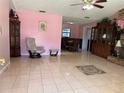 Open-concept living room features ceramic floors, accent rug, and pink walls at 231 Connie Lee Ct, Lakeland, FL 33809