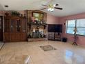 Comfortable living room featuring tile floors, brick fireplace, and bright natural lighting at 231 Connie Lee Ct, Lakeland, FL 33809