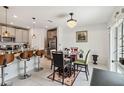 Bright dining area adjacent to the kitchen, featuring a chandelier and a table with seating for four at 356 Loch Ct, Davenport, FL 33837