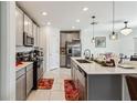 Modern kitchen featuring stainless steel appliances, granite countertops, and ample storage at 356 Loch Ct, Davenport, FL 33837