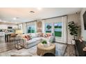 Bright, open living room with large windows and views of the backyard, with decor and modern furniture at 2212 Canyon Oak Dr, Davenport, FL 33837