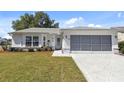 Well-maintained single-story home with a green lawn and a covered garage in a quiet neighborhood at 6202 Peacock Run, Lakeland, FL 33809