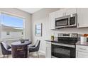 Bright eat-in kitchen with stainless steel appliances and a window with a view at 3317 Armstrong Ave, Clermont, FL 34714