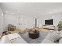 Bright living room features hardwood floors and modern decor at 438 Cotswold Cir, Davenport, FL 33837
