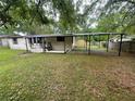 View of backyard with carport, offering ample space and privacy at 1831 Quail Trl, Lakeland, FL 33810