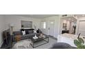 Contemporary living room with a comfortable gray sofa, stylish decor, and modern accents at 25322 Columbia Cir, Lake Wales, FL 33898