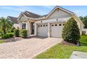 Inviting home with a brick driveway, two-car garage, and manicured landscaping at 2846 Sera Bella Way, Kissimmee, FL 34744